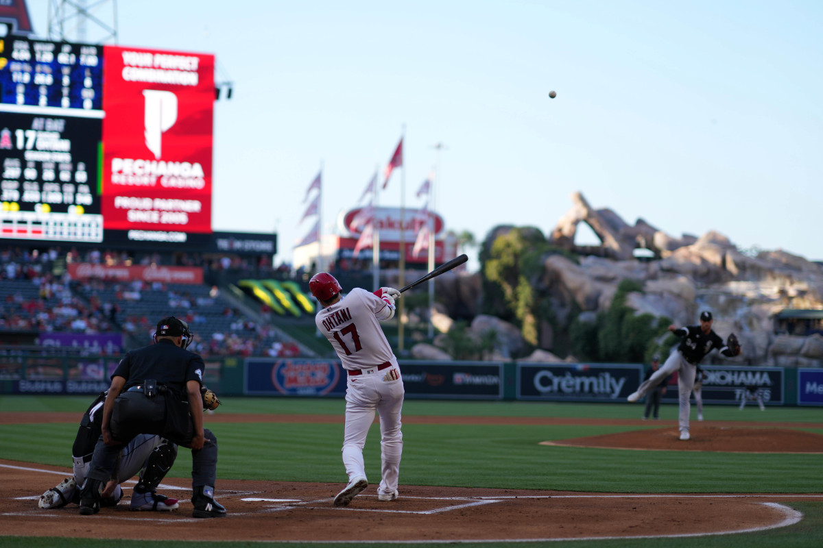 Los Angeles Angels starting pitcher Shohei Ohtani follows through on his swing as the ball flies through the air
